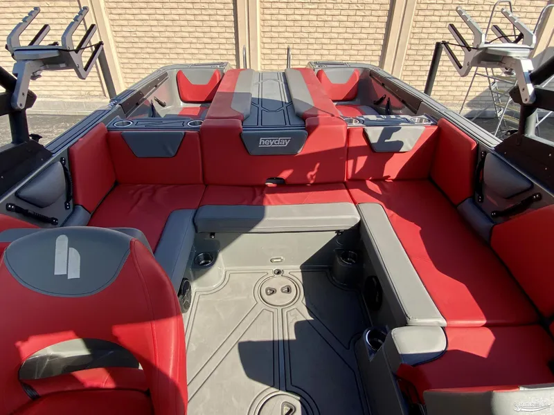Slide: The Image of 2022 Heyday WTSurf boat interior with red and gray seating. - 8