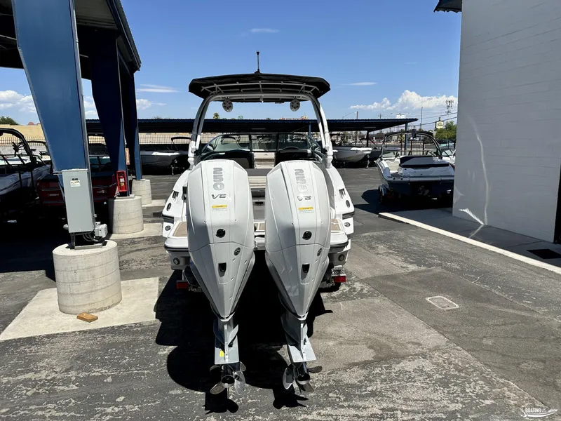 Slide: The Image of 2024 Monterey 305SS boat with dual outboard engines in a marina setting. - 11