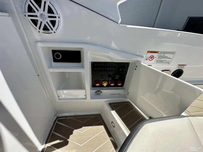 Slide: The Image of 2024 Monterey 305SS boat control panel with speaker and storage compartments. - 9