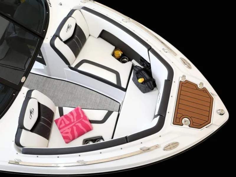 Slide: The Image of 2023 Monterey 238SS boat interior with white and black seating, pink towel, and wooden deck. - 2