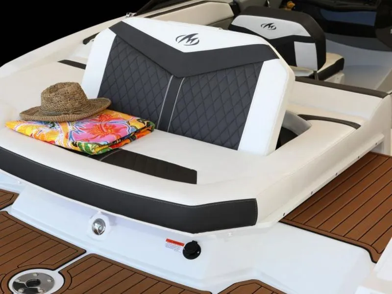 Slide: The Image of 2023 Monterey 238SS boat interior with cushioned seating, hat, and colorful towel. - 3