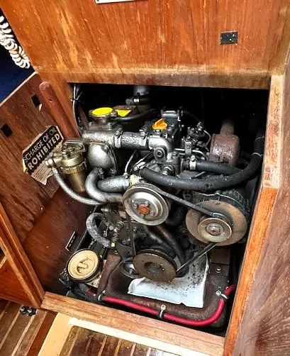 Slide: The Image of Engine compartment of a 1986 Pearson 303 sailboat, featuring a well-maintained marine engine. - 20