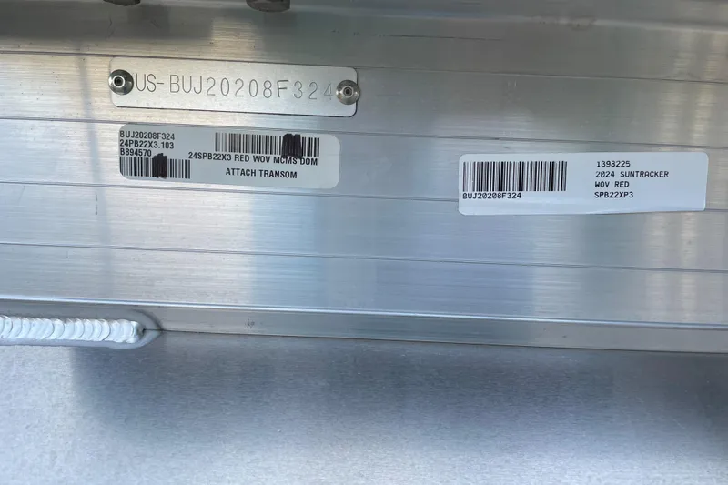 Slide: The Image of 2024 Sun Tracker Party Barge 22 XP3 identification tags and barcodes on metal surface. - 69