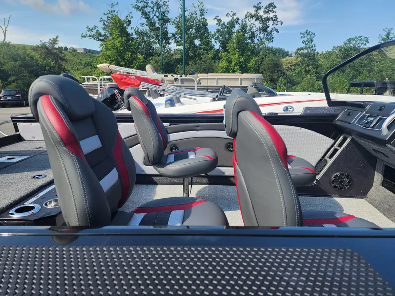 Slide: The Image of 2023 Ranger VX1888 WT boat interior with black and red seats, dashboard, and cup holders. - 3