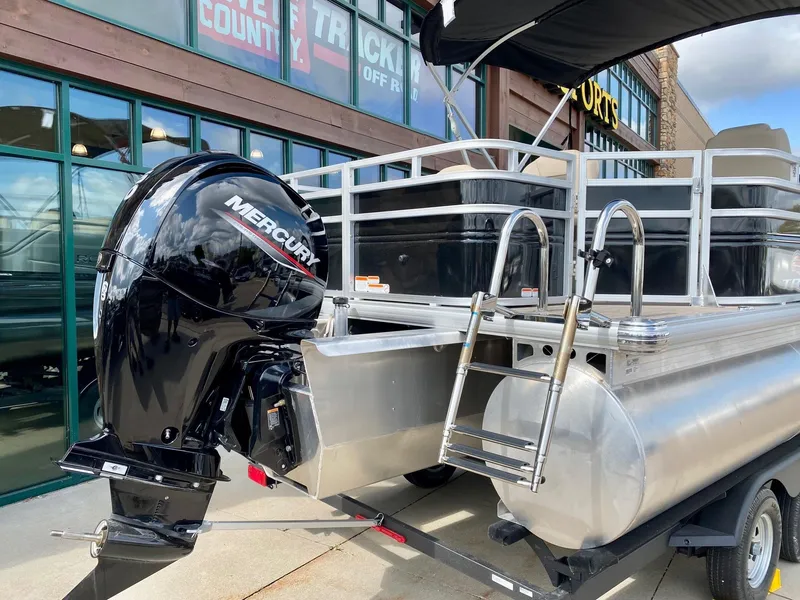 Slide: The Image of 2024 Sun Tracker SportFish 22 XP3 pontoon boat with Mercury outboard motor. - 2