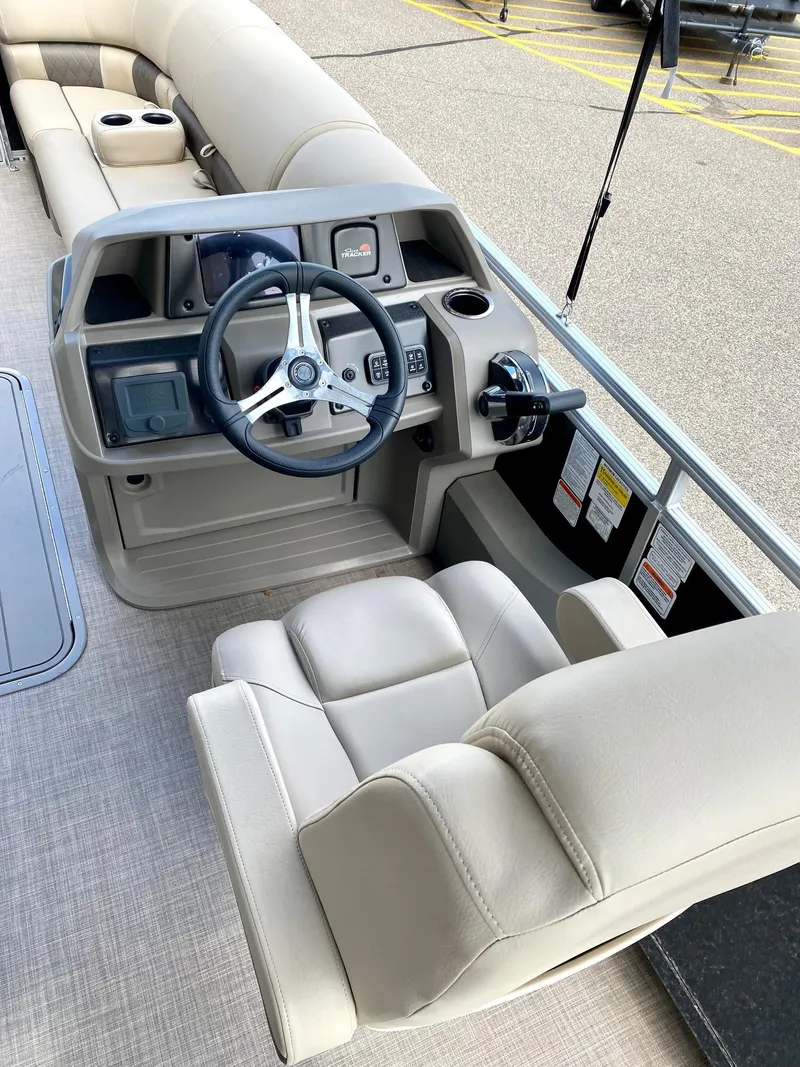 Slide: The Image of 2024 Sun Tracker SportFish 22 XP3 boat interior with steering console and seating. - 4