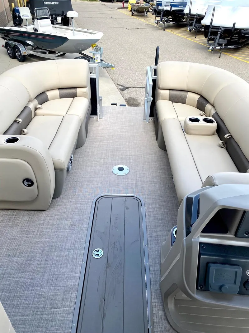 Slide: The Image of 2024 Sun Tracker SportFish 22 XP3 pontoon boat interior with beige seating. - 6