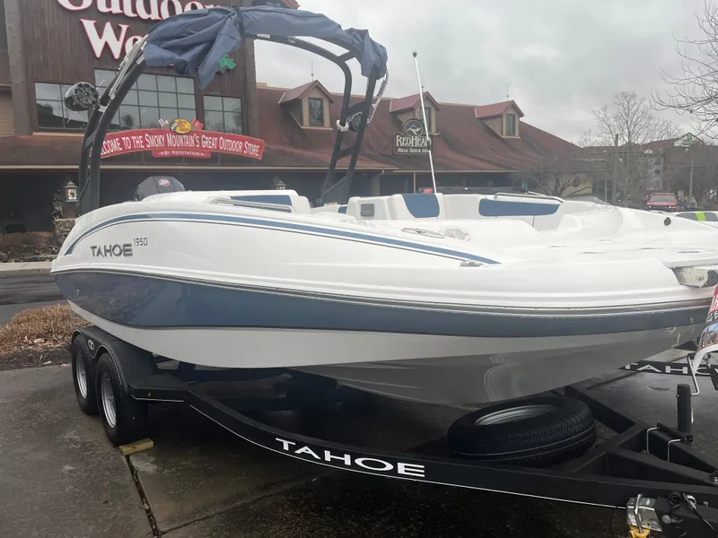 The Image of 2024 Tahoe 1950 boat on trailer outside a store. - 0