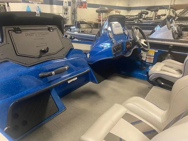 Slide: The Image of 2024 Nitro Z18 Pro boat interior with blue dashboard and seating. - 9