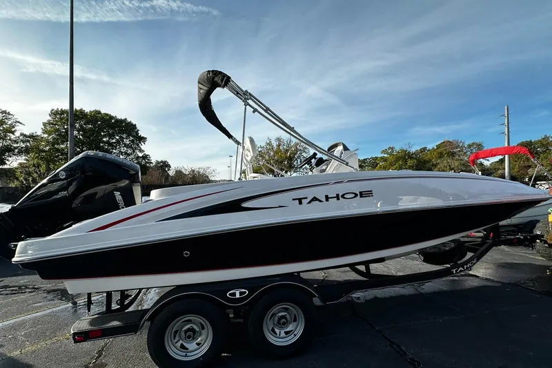 Slide: The Image of 2024 Tahoe 2150 CC boat on a trailer under a clear sky. - 0