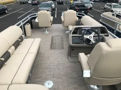 Slide: The Image of 2024 Sun Tracker Sportfish 24 XP3 pontoon boat interior with beige seating. - 11
