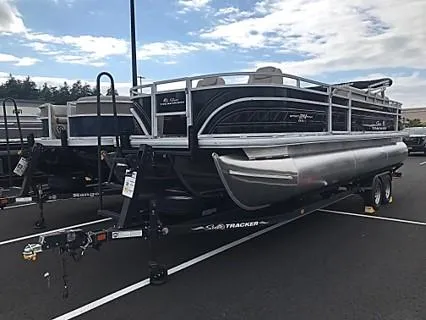 Slide: The Image of 2024 Sun Tracker Sportfish 24 XP3 pontoon boat on trailer in parking lot. - 4