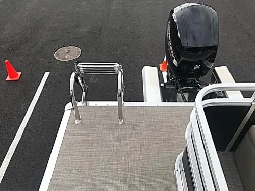 Slide: The Image of 2024 Sun Tracker Sportfish 24 XP3 boat rear deck with motor and ladder. - 9