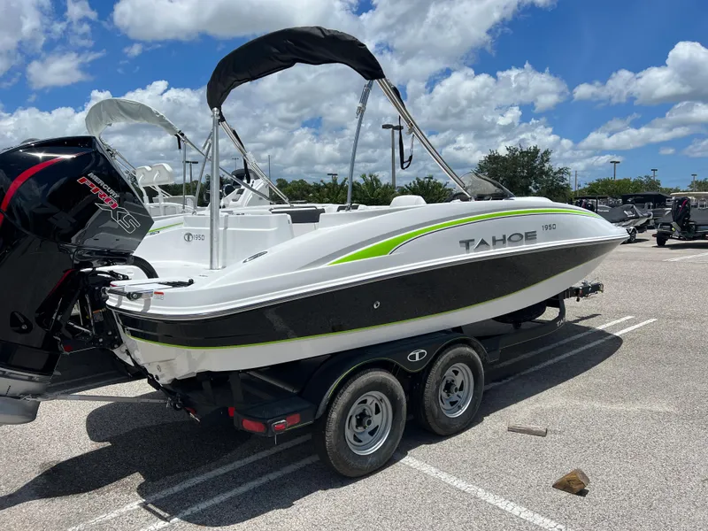 Slide: The Image of 2024 Tahoe 1950 boat on trailer in parking lot under blue sky. - 3