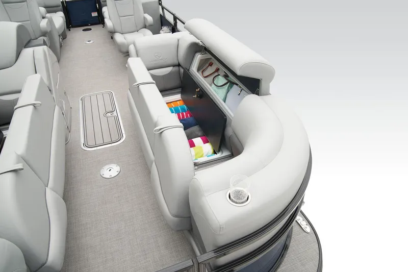 Slide: The Image of 2024 Regency 230 DL3 pontoon boat interior with storage compartment and seating. - 15