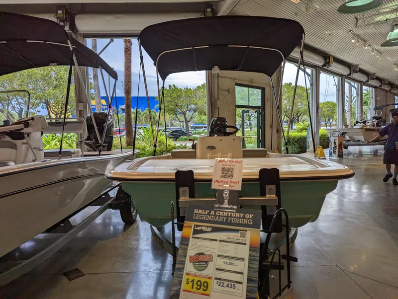 Slide: The Image of 2024 Mako Pro Skiff 13 CC fishing boat displayed in showroom. - 2