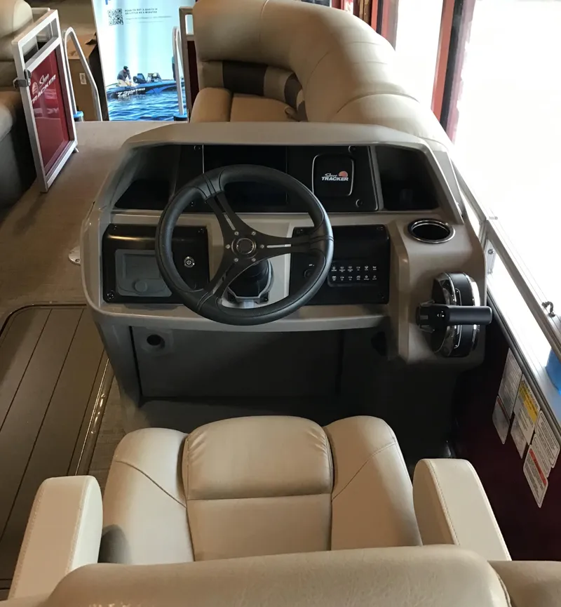 Slide: The Image of 2024 Sun Tracker Party Barge 22 RF XP3 helm with plush seating and modern controls. - 3