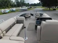 Slide: The Image of 2024 Sun Tracker Fishin' Barge 22 XP3 pontoon boat with spacious seating and modern amenities. - 12