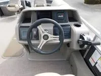 Slide: The Image of 2024 Sun Tracker Fishin' Barge 22 XP3 steering console with modern controls. - 9