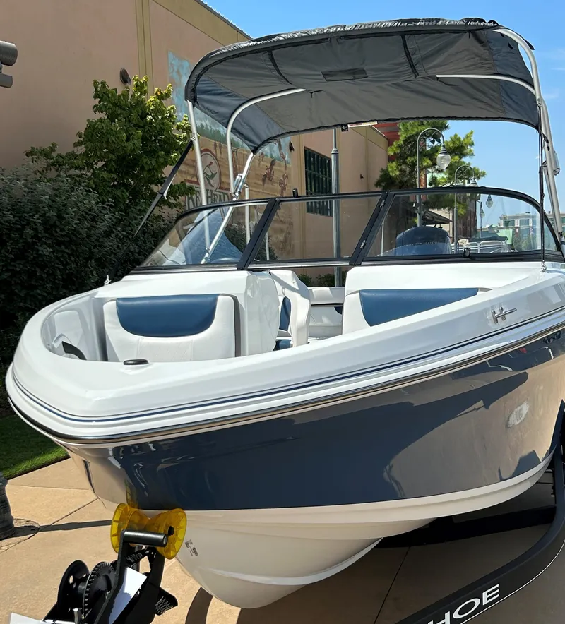 Slide: The Image of 2024 Tahoe 185 S boat with canopy on display outdoors. - 5