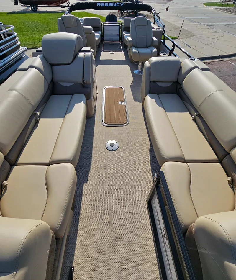 Slide: The Image of 2024 Regency 230 DL3 pontoon boat with spacious seating and luxurious interior. - 10
