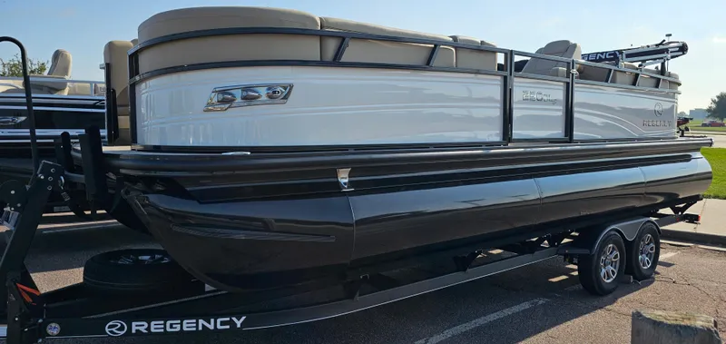 Slide: The Image of 2024 Regency 230 DL3 pontoon boat on a trailer. - 2