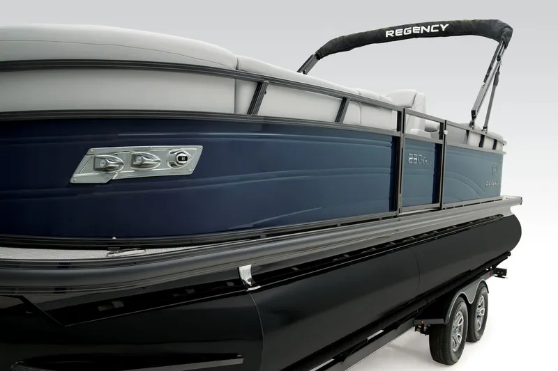 Slide: The Image of 2024 Regency 230 DL3 pontoon boat, side view, sleek design, blue and black color scheme. - 22