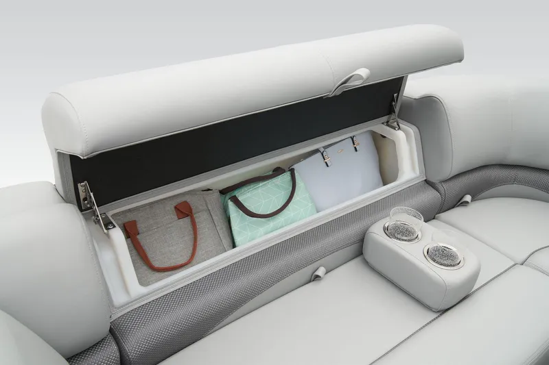 Slide: The Image of 2024 Regency 230 DL3 boat interior storage compartment with bags and cup holders. - 28