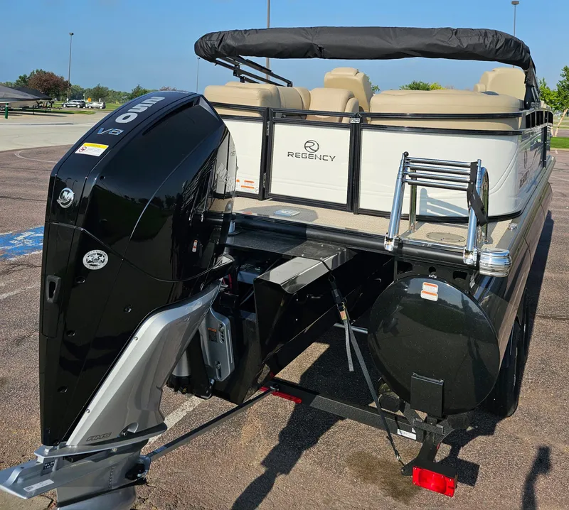 Slide: The Image of 2024 Regency 230 DL3 pontoon boat with powerful outboard motor. - 3