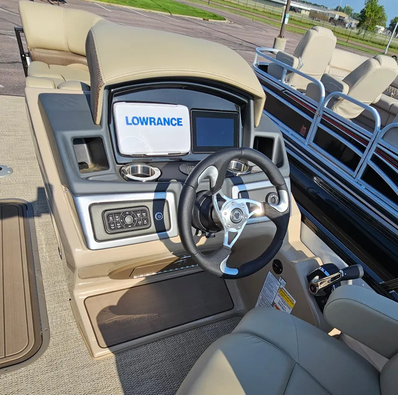 Slide: The Image of 2024 Regency 230 DL3 boat dashboard with Lowrance navigation system and steering wheel. - 6