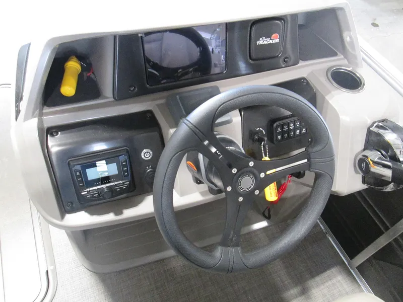 Slide: The Image of 2024 Sun Tracker Party Barge 22 XP3 helm with steering wheel and control panel. - 13