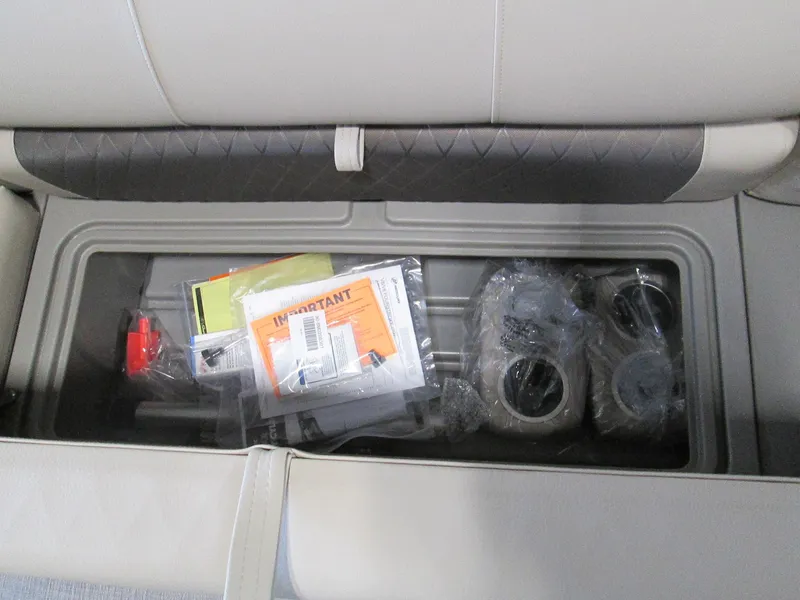 Slide: The Image of Storage compartment in 2024 Sun Tracker Party Barge 22 XP3 with manuals and accessories. - 5