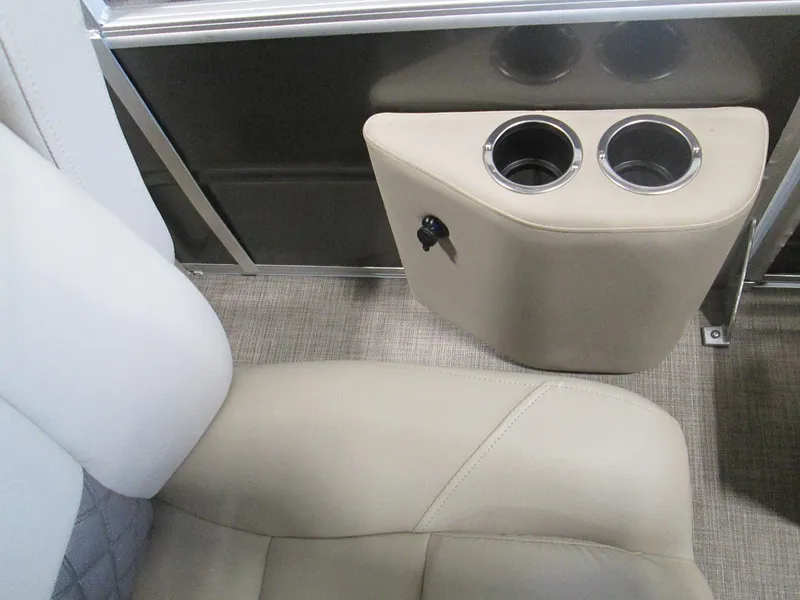 Slide: The Image of 2024 Sun Tracker Party Barge 22 XP3 interior with beige seating and cup holders. - 8