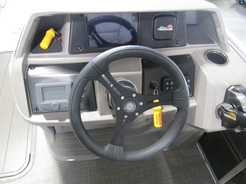 Slide: The Image of 2024 Sun Tracker Party Barge 22 XP3 steering console with controls and gauges. - 9