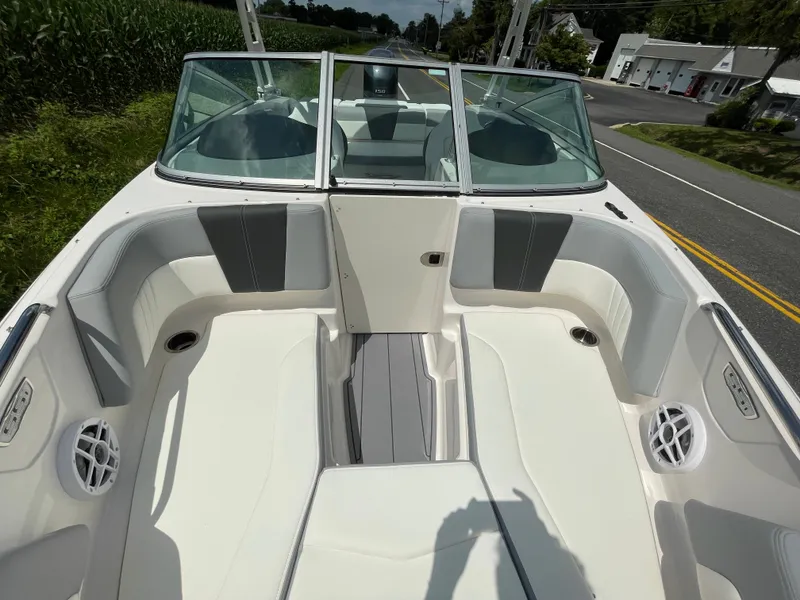 Slide: The Image of 2024 Chaparral 21 SSi OB boat interior with white and gray seating. - 12