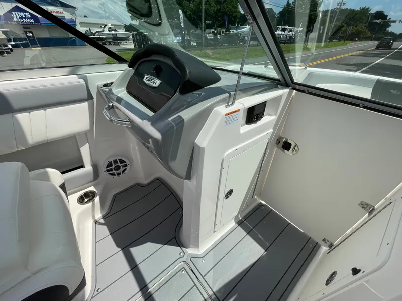 Slide: The Image of 2024 Chaparral 21 SSi OB boat interior, helm station, and seating area. - 16
