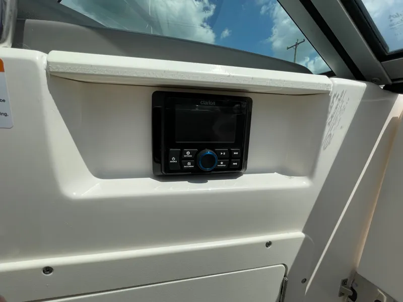 Slide: The Image of 2024 Chaparral 21 SSi OB boat dashboard with a built-in audio system. - 17