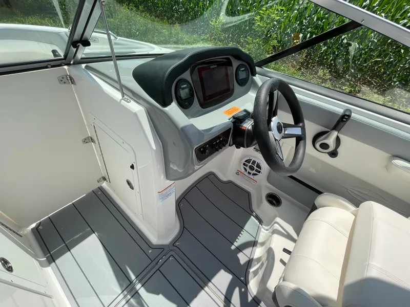 Slide: The Image of 2024 Chaparral 21 SSi OB boat cockpit with steering wheel and dashboard. - 21