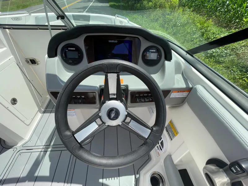 Slide: The Image of 2024 Chaparral 21 SSi OB boat dashboard with steering wheel and instrument panel. - 23