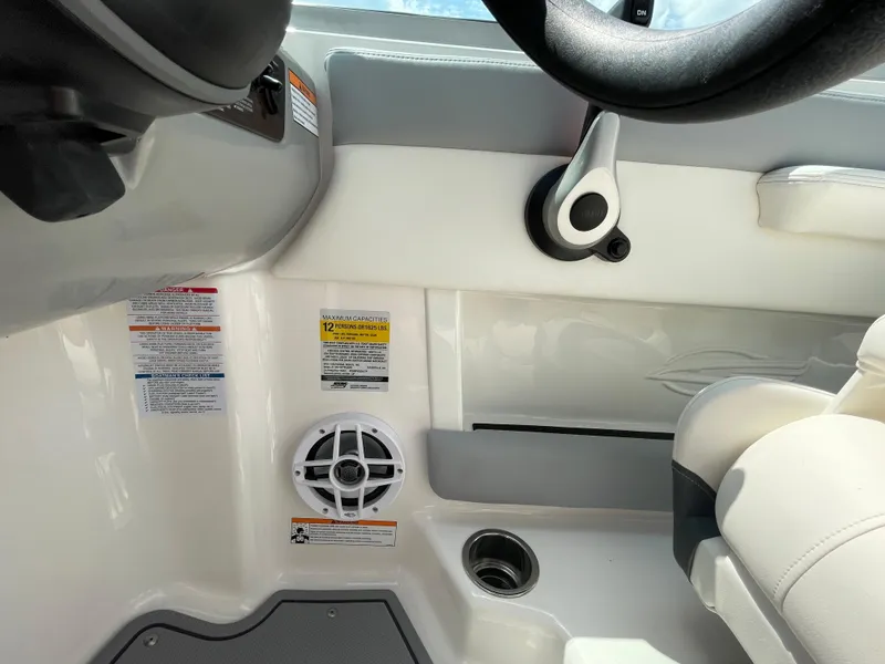 Slide: The Image of 2024 Chaparral 21 SSi OB boat interior, featuring steering wheel and speaker. - 28