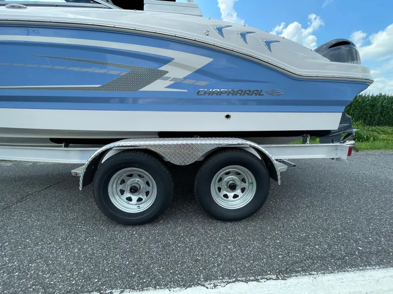 Slide: The Image of 2024 Chaparral 21 SSi OB boat on a dual-axle trailer, side view. - 3