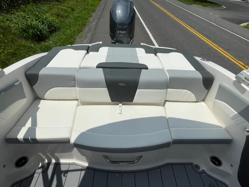 Slide: The Image of 2024 Chaparral 21 SSi OB boat with spacious rear seating and outboard motor. - 33