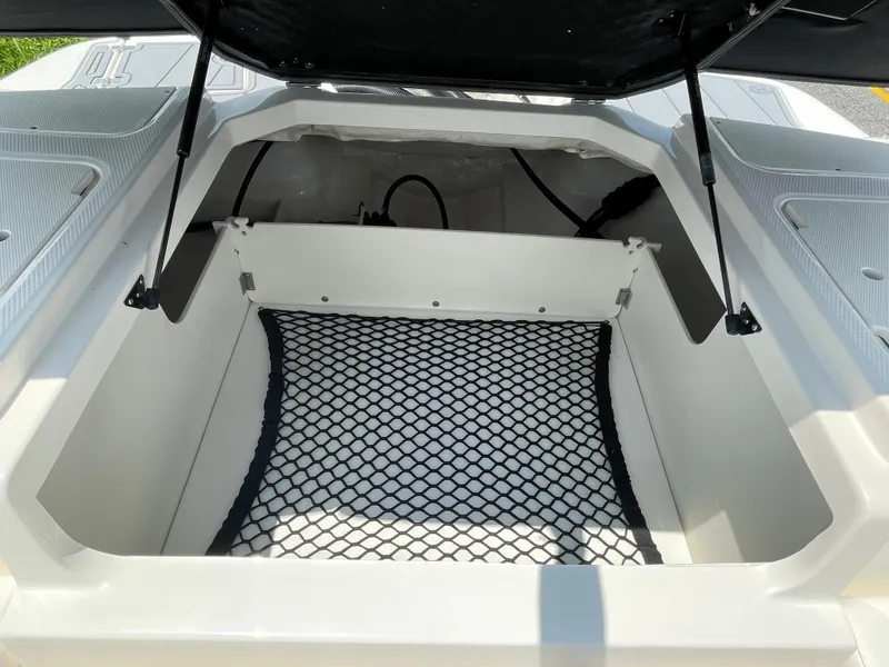 Slide: The Image of Open storage compartment of 2024 Chaparral 21 SSi OB boat with netting. - 34