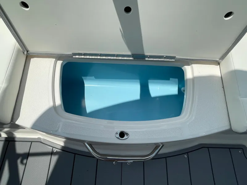 Slide: The Image of Open storage compartment on a 2024 Chaparral 21 SSi OB boat. - 36