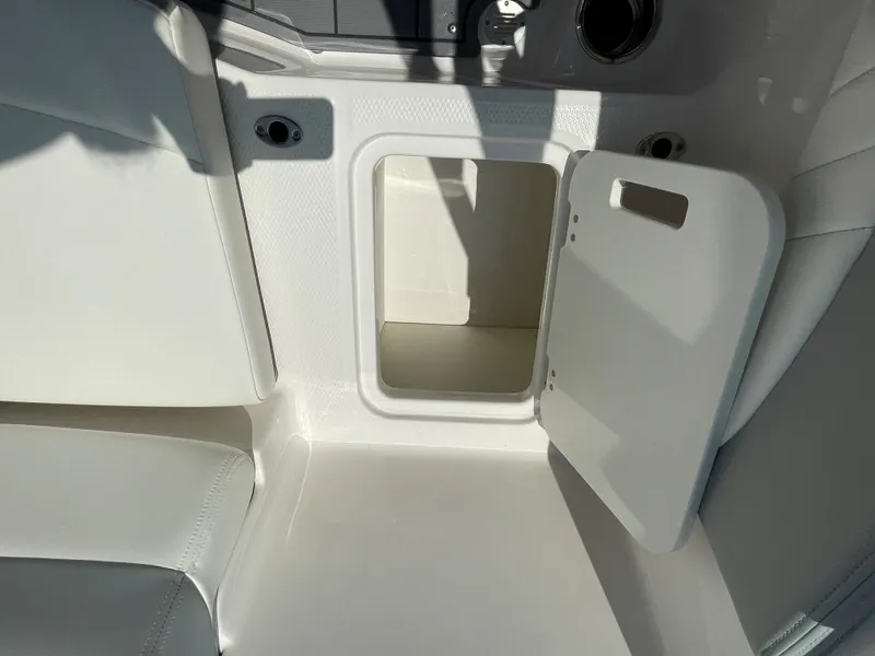 Slide: The Image of Open storage compartment in 2024 Chaparral 21 SSi OB boat. - 38