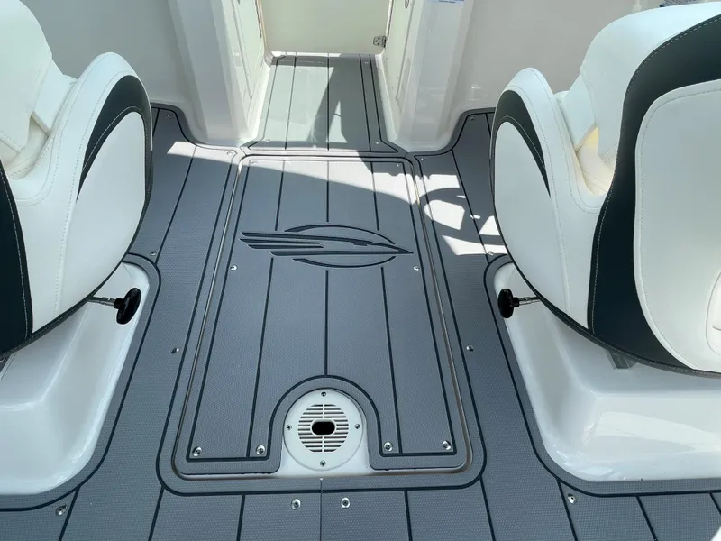 Slide: The Image of 2024 Chaparral 21 SSi OB boat interior with grey flooring and white seats. - 42