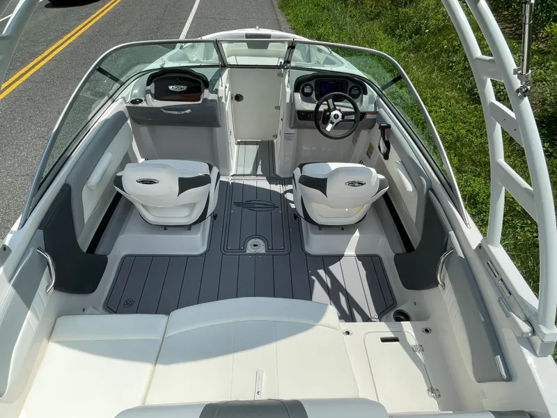 Slide: The Image of 2024 Chaparral 21 SSi OB boat interior with dual captain seats and modern dashboard. - 45