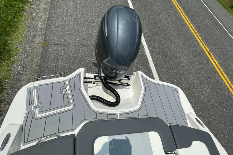Slide: The Image of 2024 Chaparral 21 SSi OB boat with outboard motor on a road. - 47