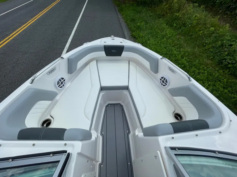 Slide: The Image of 2024 Chaparral 21 SSi OB boat interior with cushioned seating and speakers. - 5