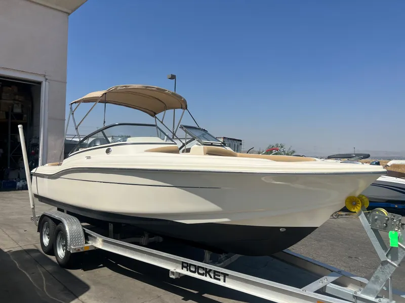 The Image of 2019 Scout 210 Dorado boat on a trailer in a marina. - 1